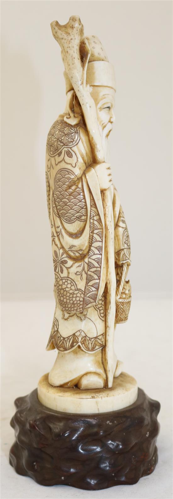 A Japanese ivory figure of a sage, early 20th century, height 25.5cm including wood stand